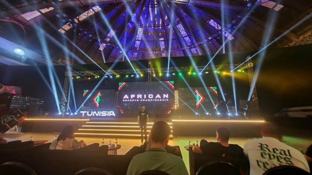 Nigerian esports players competing in a gaming tournament with colorful LED screens and professional gaming setups