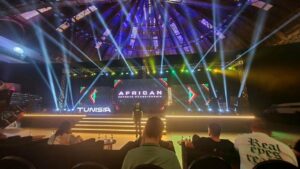 Nigerian esports players competing in a gaming tournament with colorful LED screens and professional gaming setups